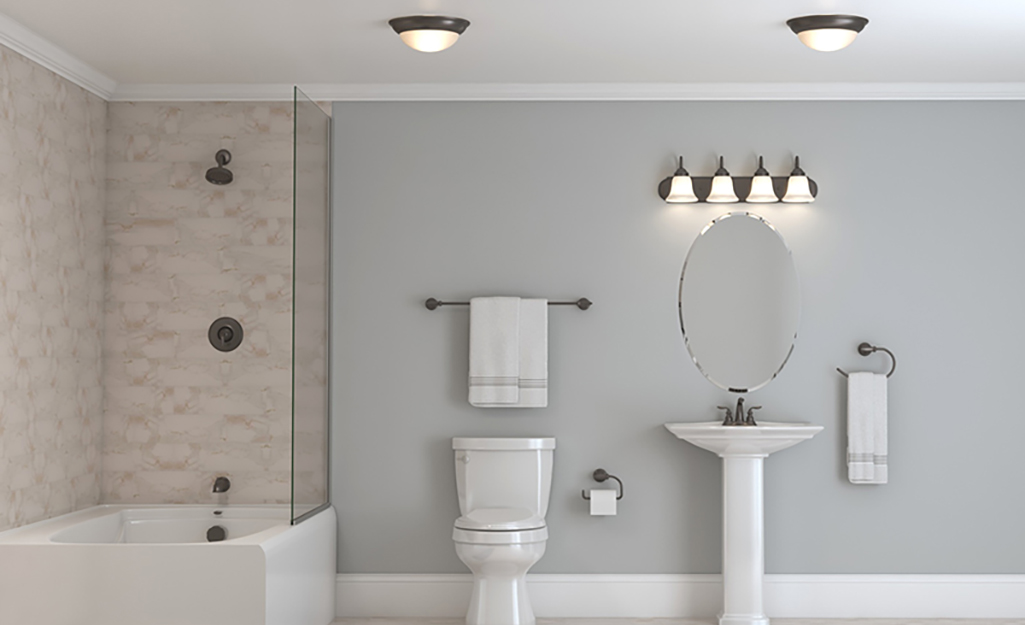 A bathroom featuring flush-mount ceiling lights and a light bar over the vanity.