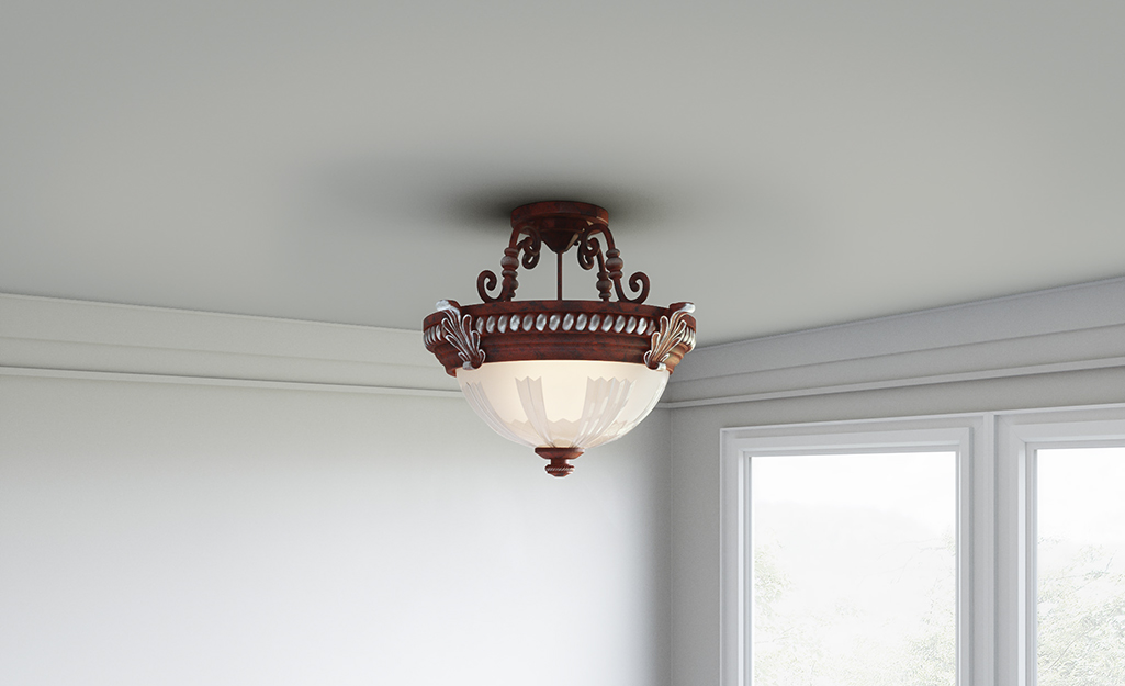 An antique dome-shaped semi-flush mount light.