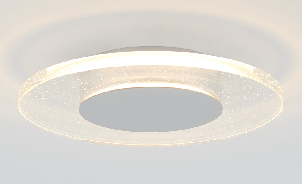 A flush mount light with a glass shade.