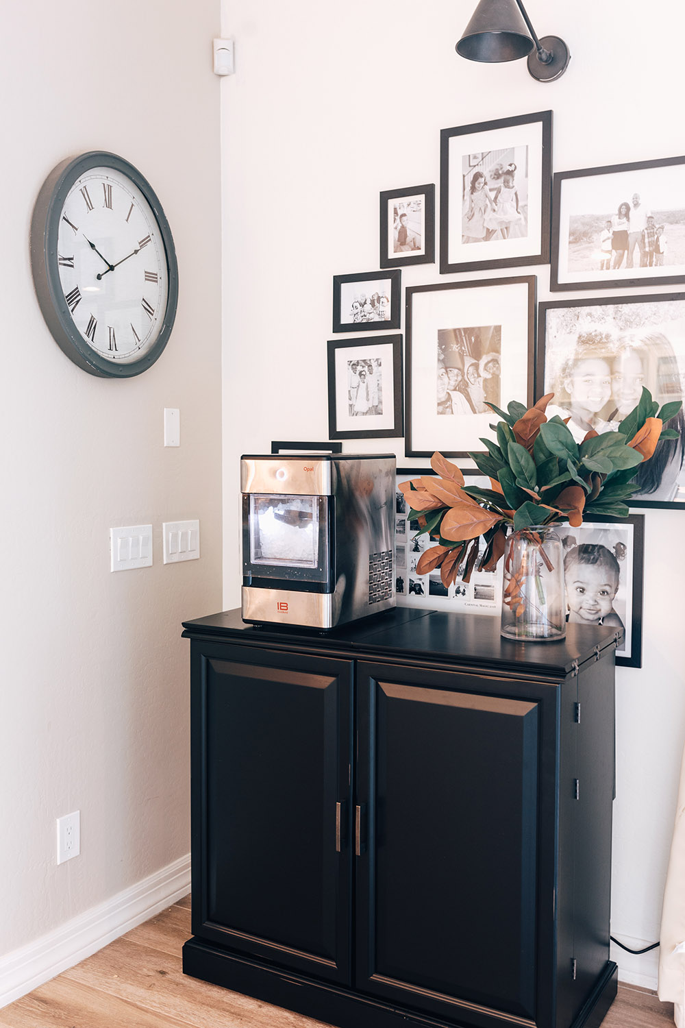 A bar cabinet against a decorated wall.