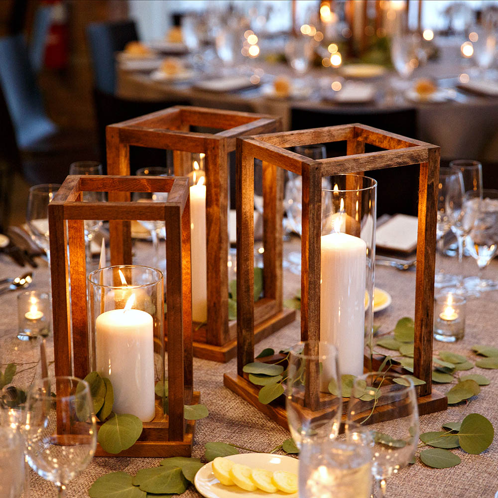 A table decorated with DIY wooden lanterns.