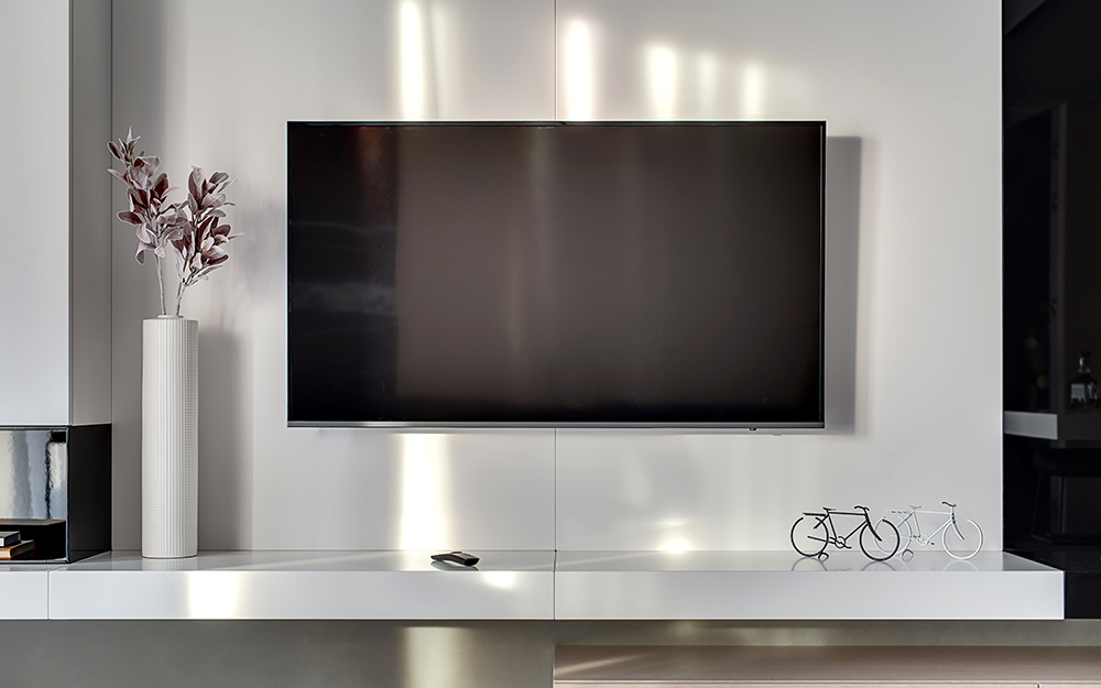 A flat screen television mounted on a wall.