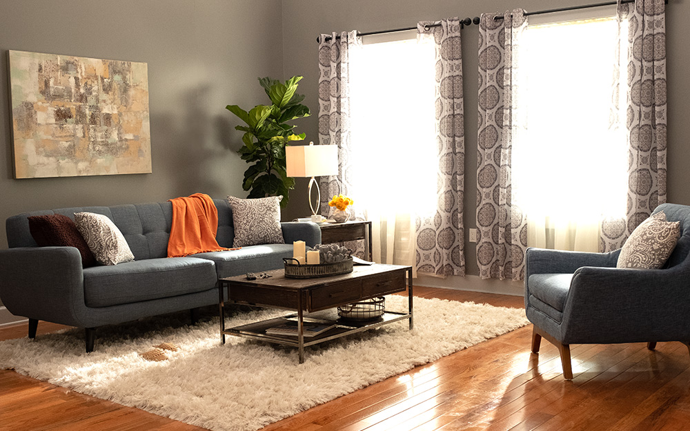 A living room with leather chair and sofa.