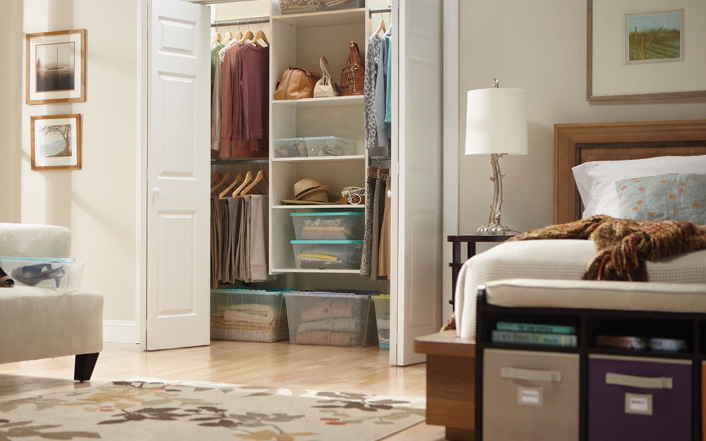 A bedroom with an open closet.