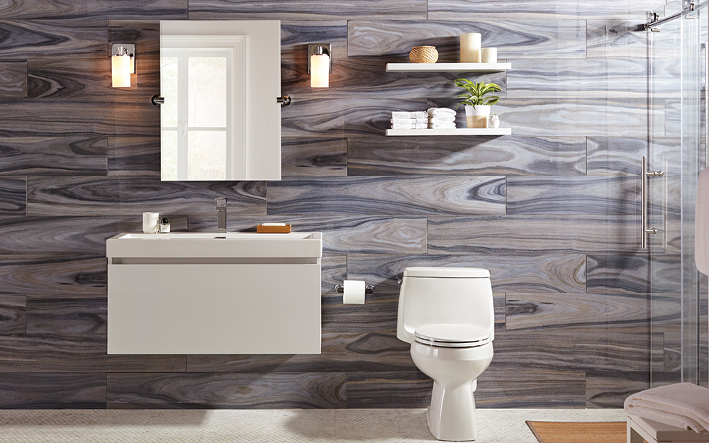 Wood-like horizontal tile behind a taupe and white single vanity.