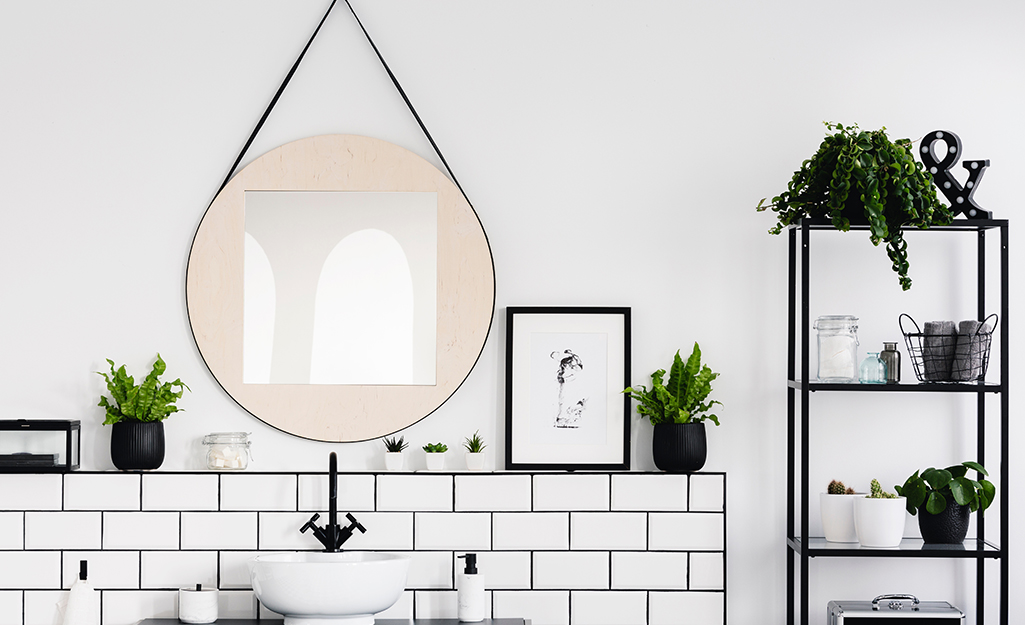 A small bathroom with built-in ledge and added bookshelves.