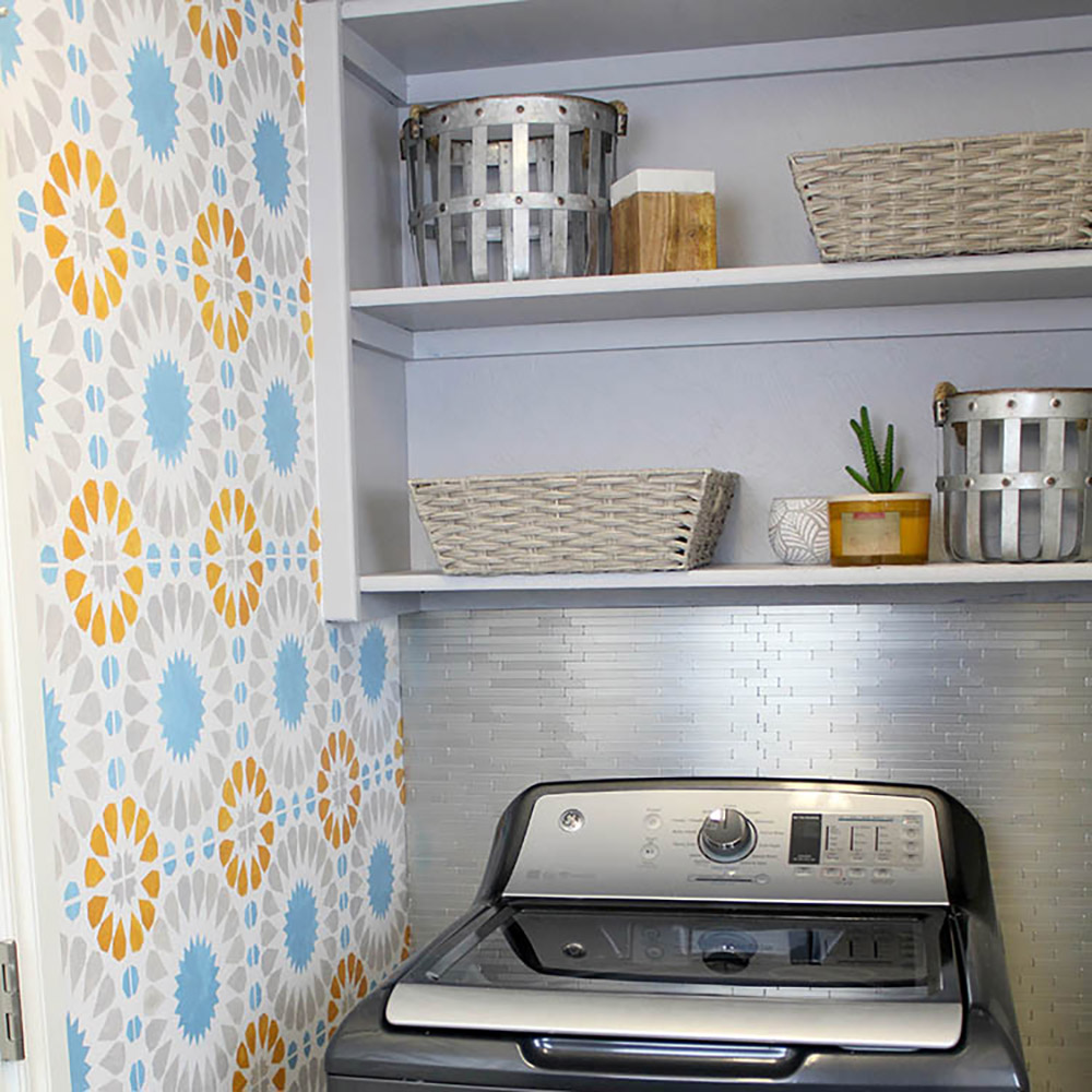 A small laundry room with an accent wall.