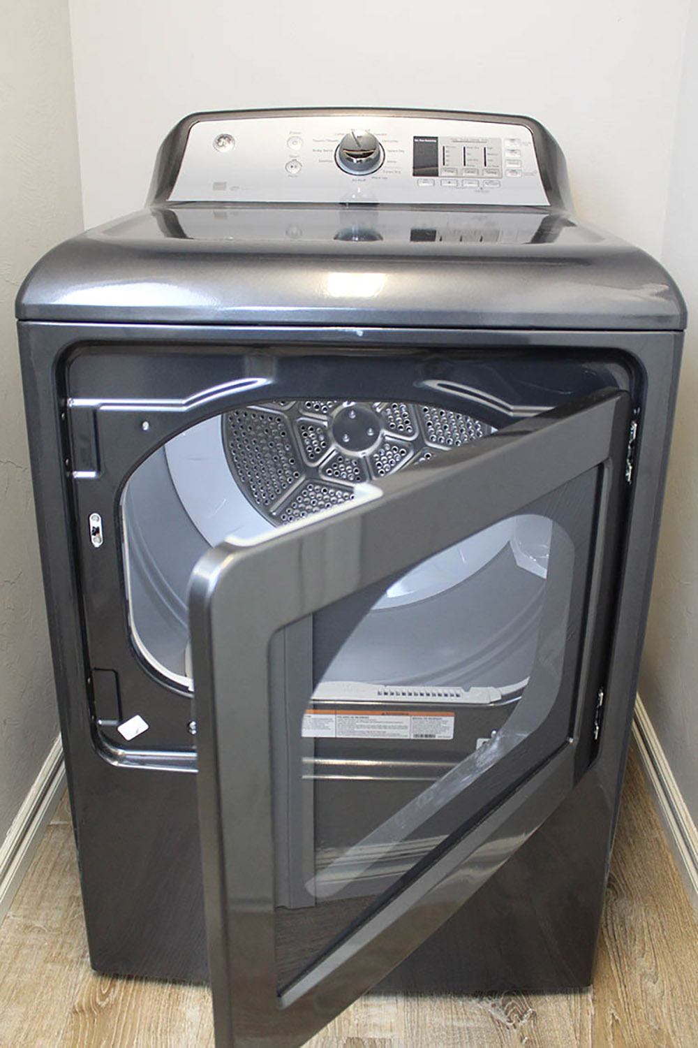 A new gray GE dryer with the door open.