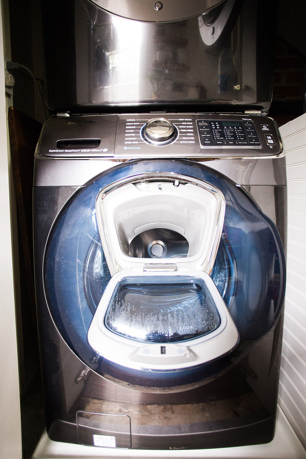 A closet with a washing machine.