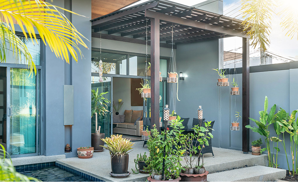 A small patio covered by a pergola.