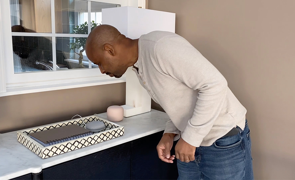 Man checking a smart home hub device.