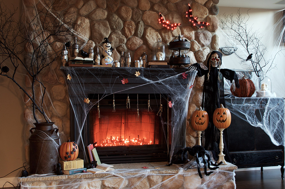 A fireplace and mantel decorated for Halloween.