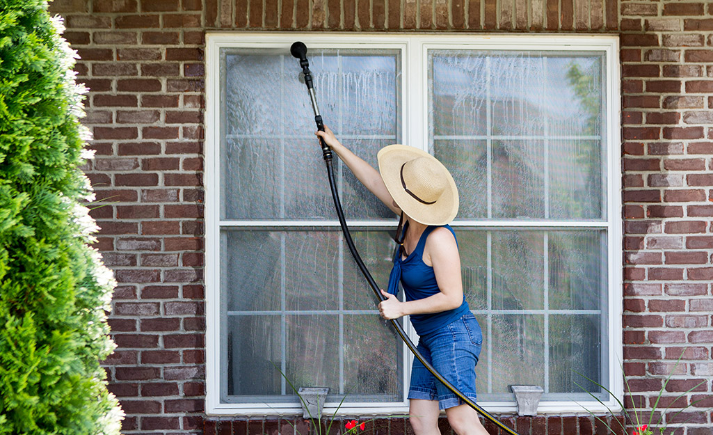 Homeowner washing windows