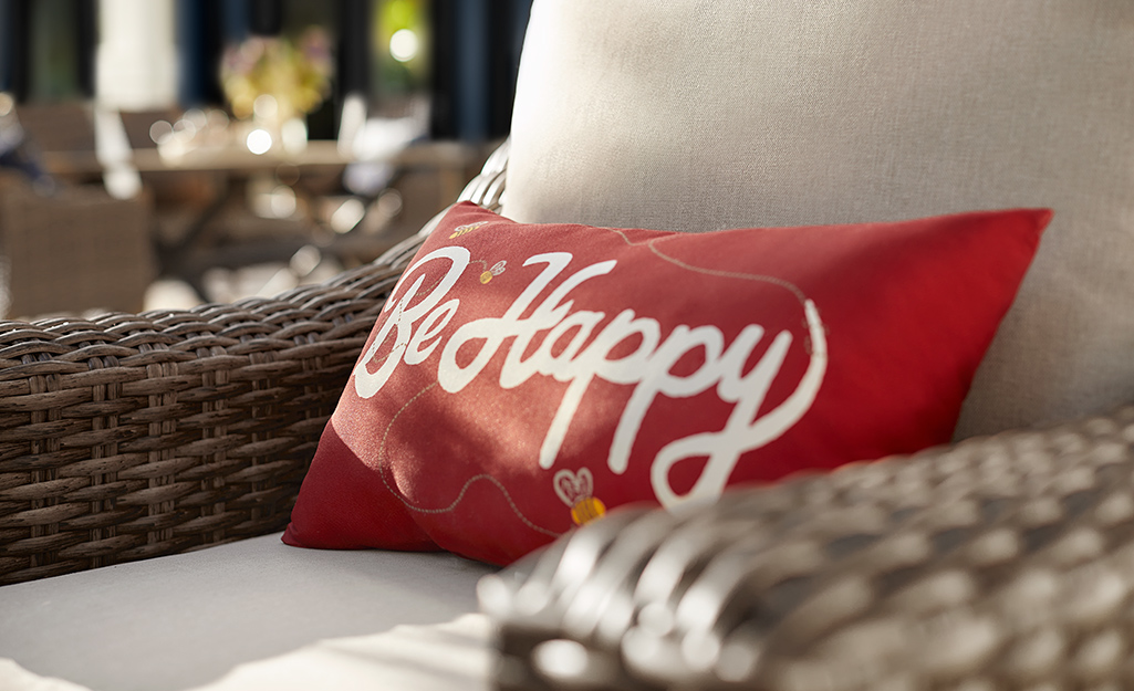 A red accent pillow on outdoor seating. A red accent pillow on outdoor seating.