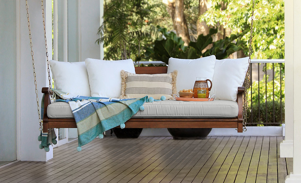 A gorgeous outdoor porch swing with white pillows. A gorgeous outdoor porch swing with white pillows.