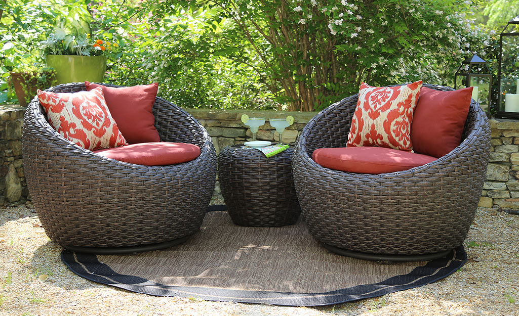 A pair of wicker patio chairs.