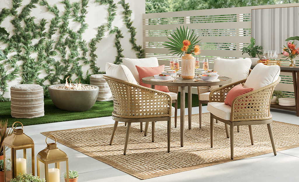 A patio table has four chairs with oversized cushions.