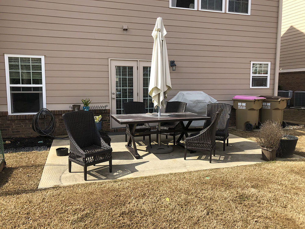 A patio with a wicker dining set. A patio with a wicker dining set.