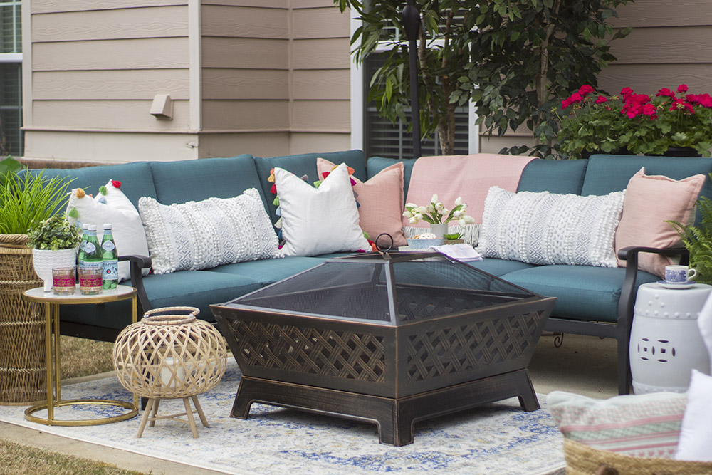An outdoor sectional is decorated with white and pink pillows. An outdoor sectional is decorated with white and pink pillows.