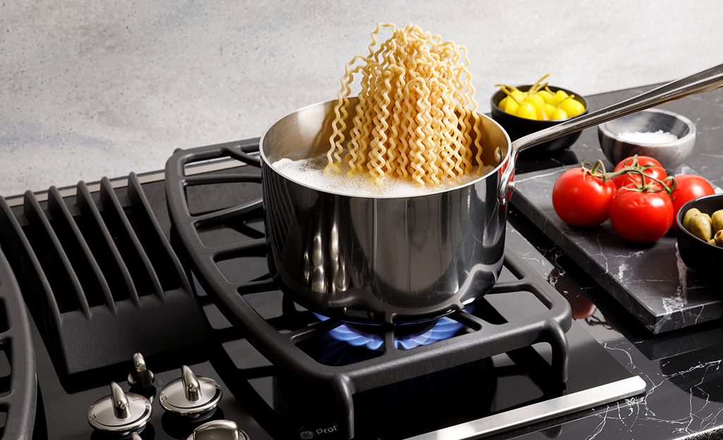Noodles cooking on gas stove. Noodles cooking on gas stove.