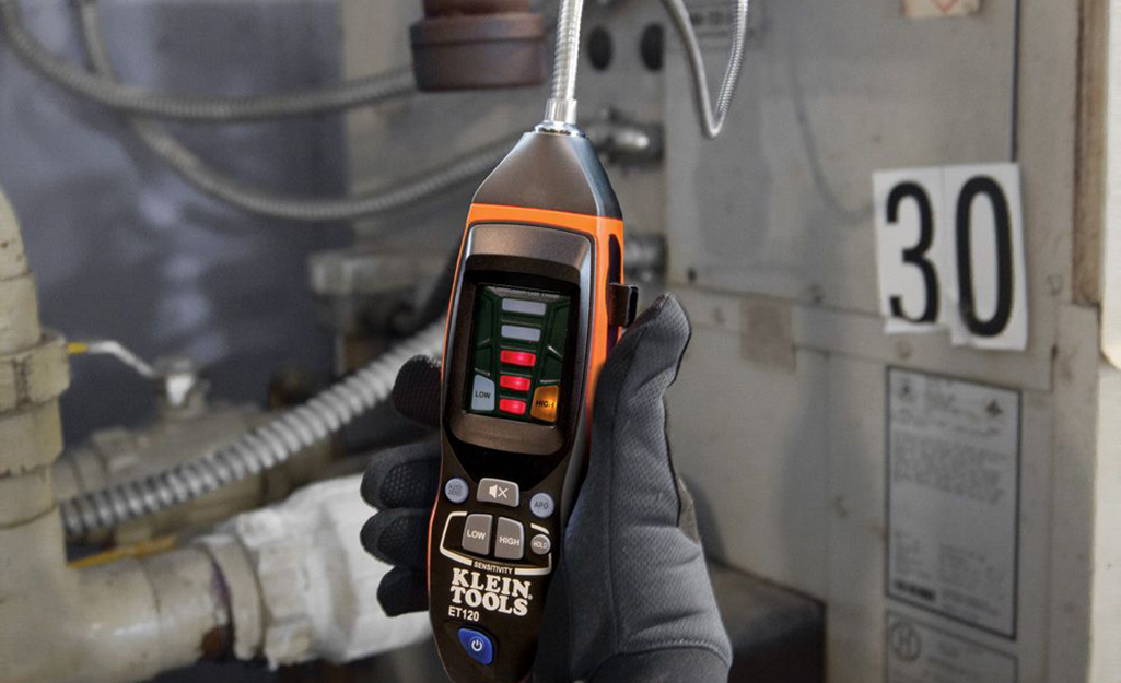 A person using a gas detector. 