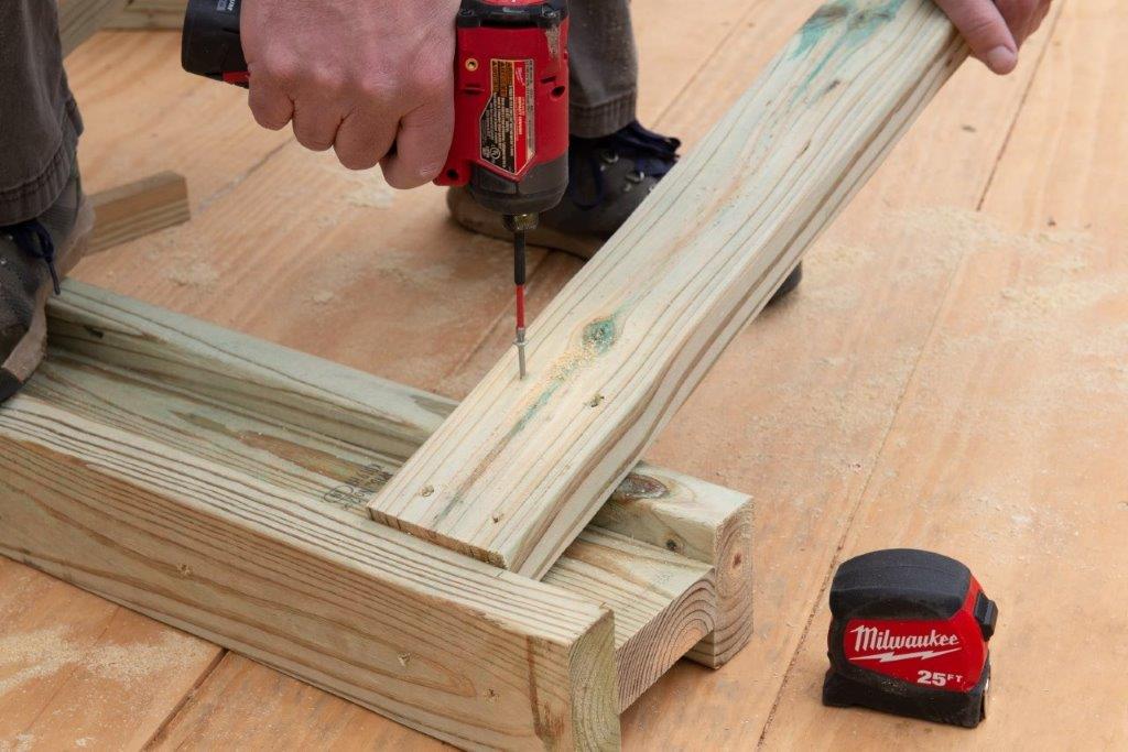 A pro screws the legs into the I-beam. A pro screws the legs into the I-beam.