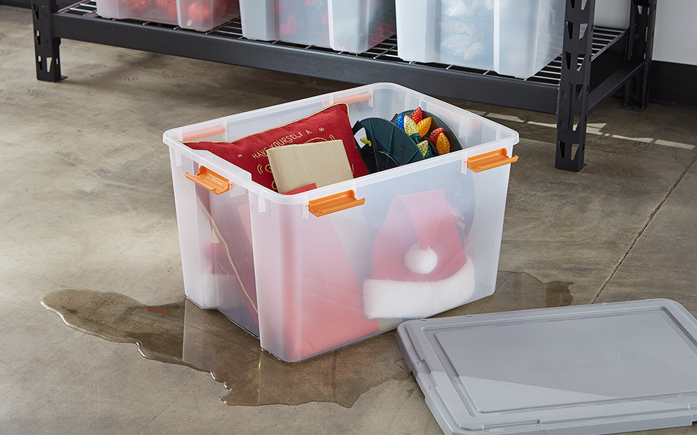 A plastic storage bin holding holiday decorations.