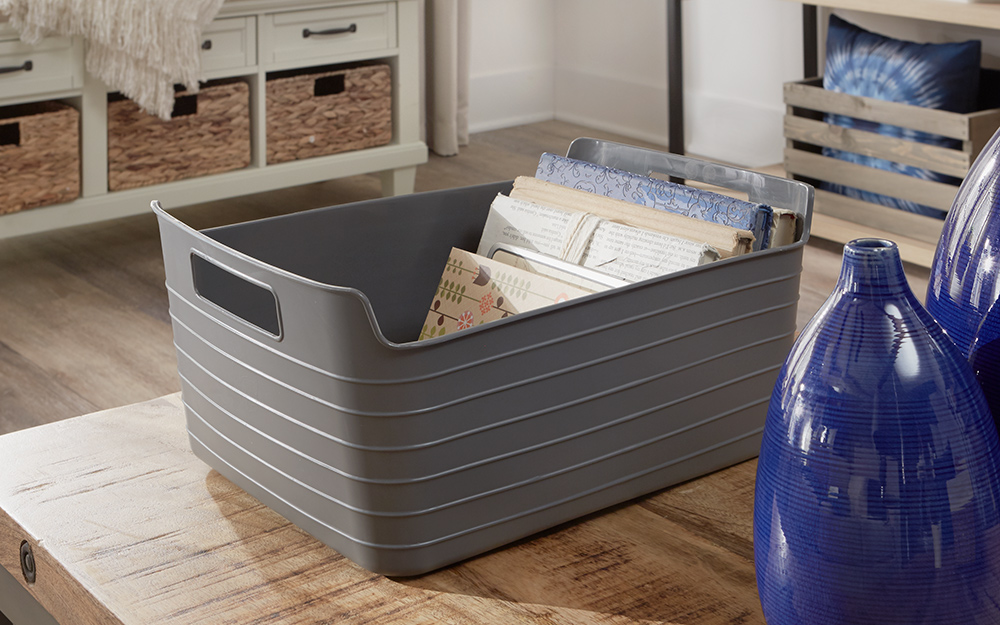 A storage tote holding papers and books.