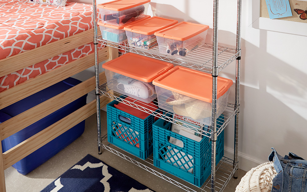 Storage totes and crates stacked on a shelf organizer.