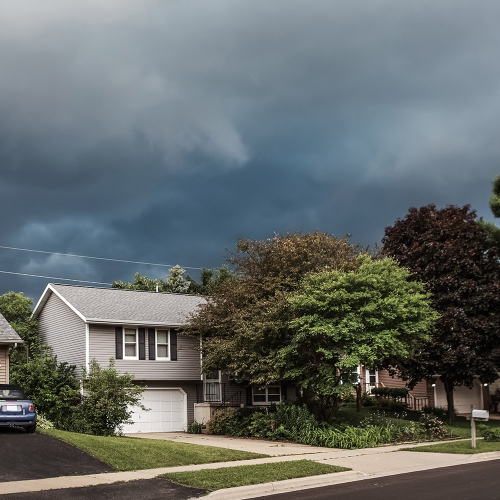 A storm is brewing behind a house.