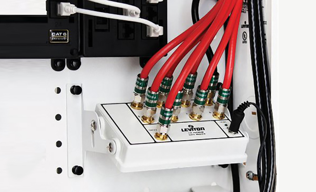 Red cables connect to ports in a small white panel.