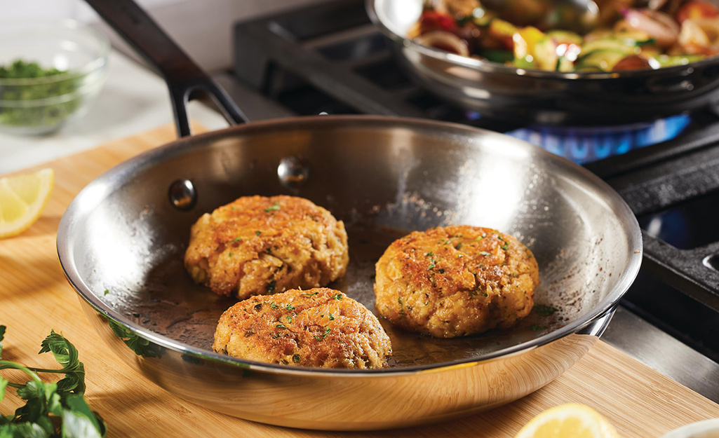 Crab cakes in a Stainless steel pan. 