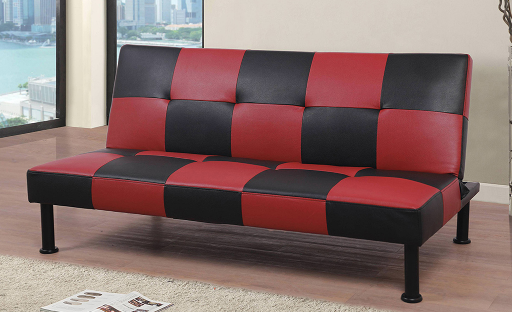 A red and black checkered cover on a futon.
