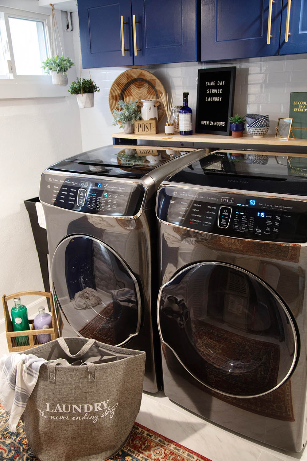 A laundry room with Samsung black stainless laundry appliances.