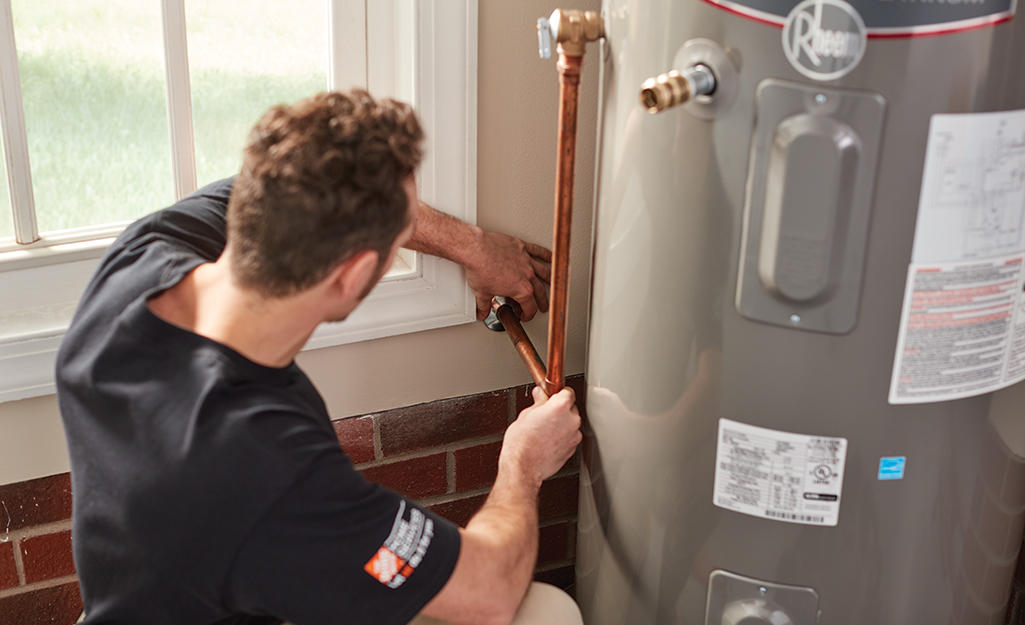 Licensed professional repairing a water heater.