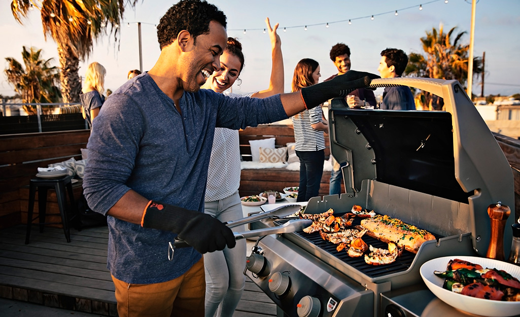 A man grills food on an outdoor grill.