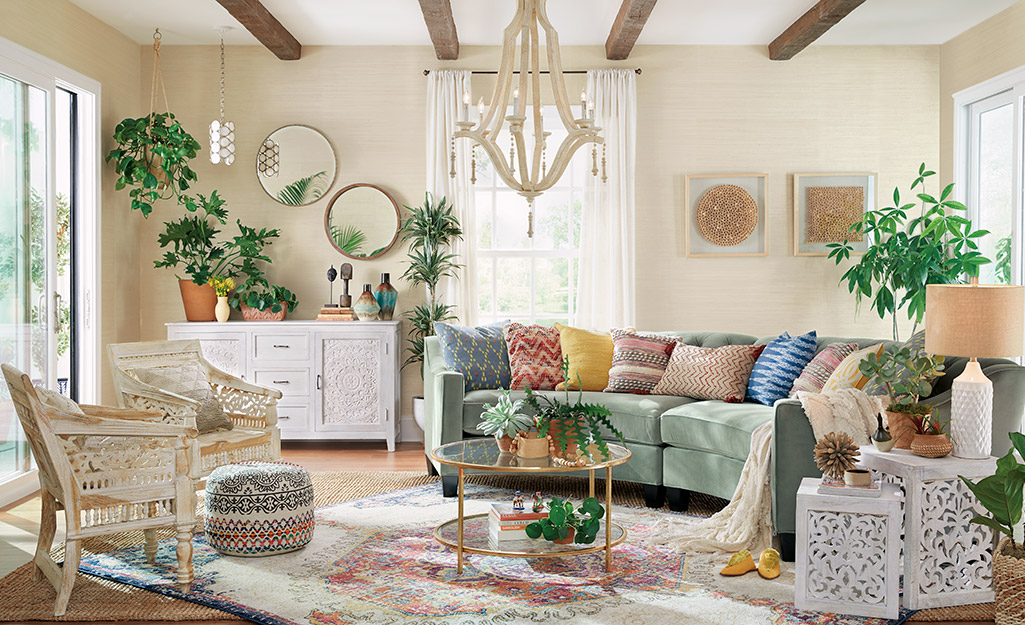 A living area with sofas, chairs and houseplants