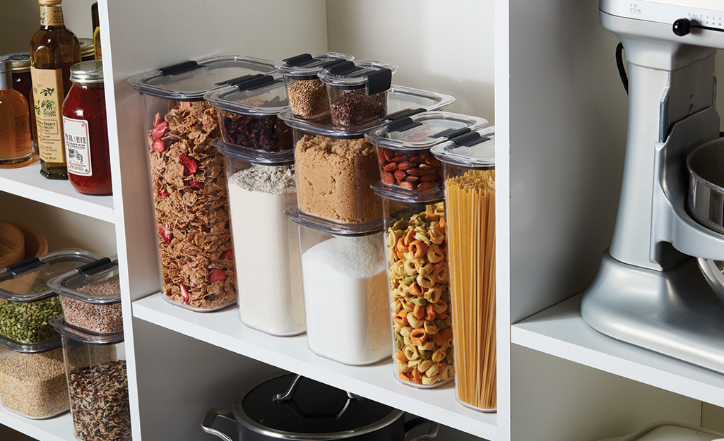 A pantry stores pasta, breakfast cereal and other items in transparent containers.