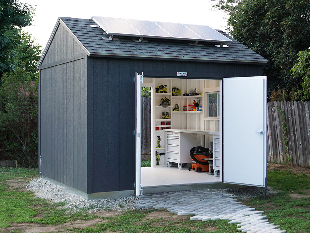 The interior of a Tuff Shed is exposed through open double doors.