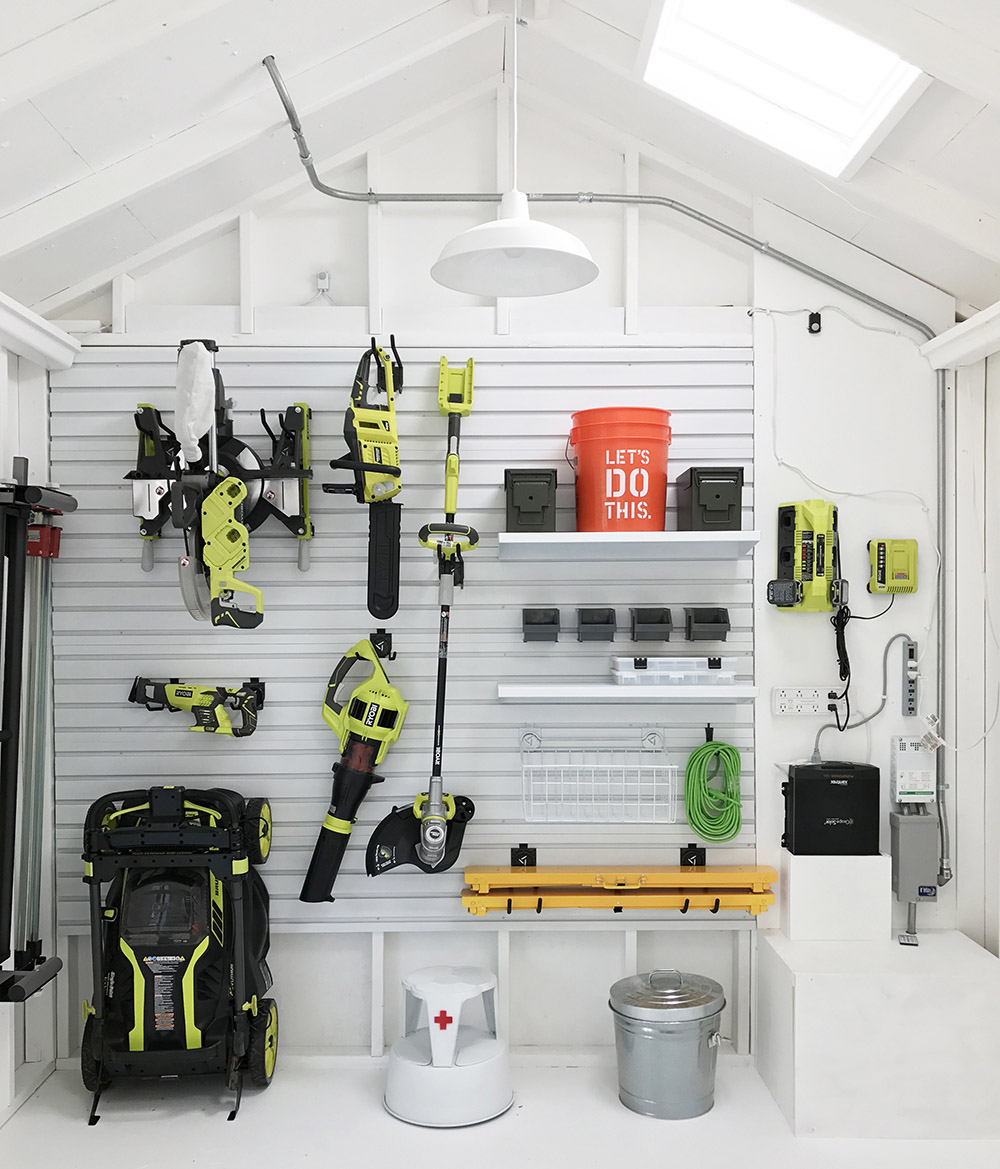 A organized interior shed wall filled with tools.