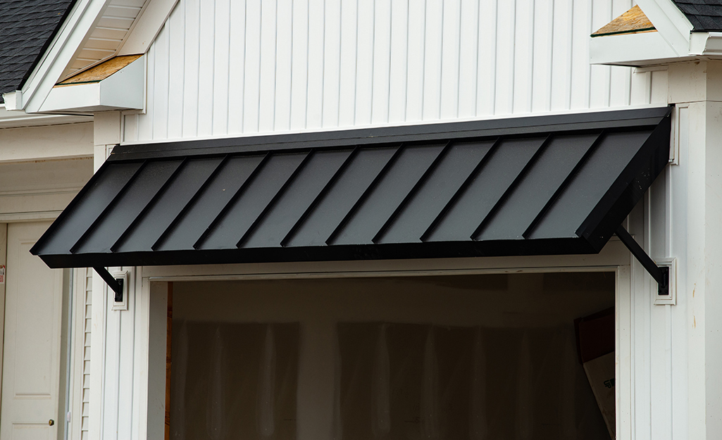 A black metal awning over a window.