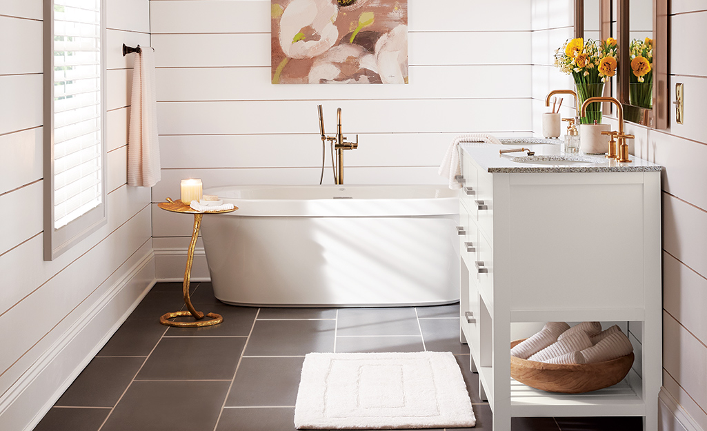 A bathroom with sculpted taller baseboard moulding.