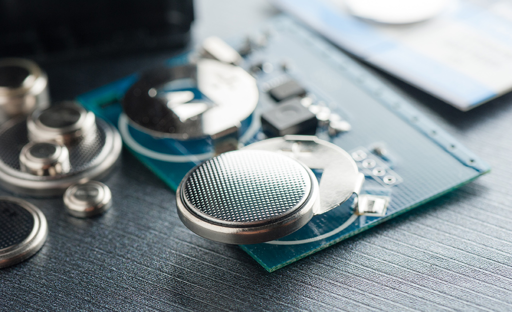 A coin cell battery inserted in a portable electronic device.. 