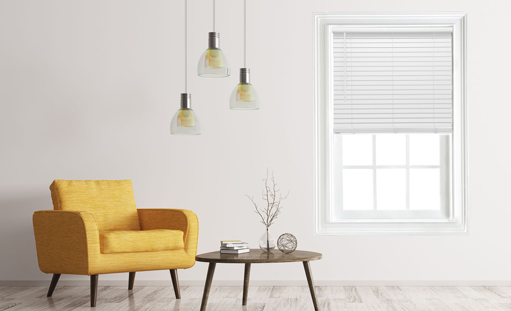 White cordless blinds cover a window in a contemporary room with a retro yellow chair and side table.