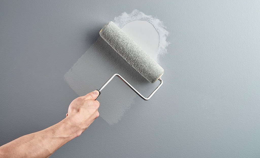 A small area of paintable caulk being painted over with a brush.