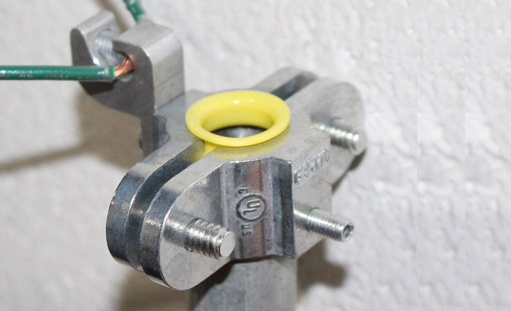 A metal coupling featuring a yellow brushing.