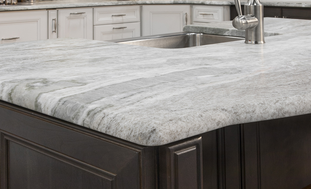 A natural stone countertop with half bullnose edges.