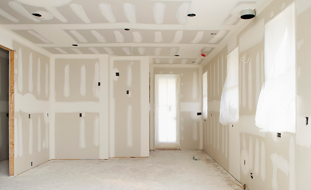 An empty space with exposed drywall.
