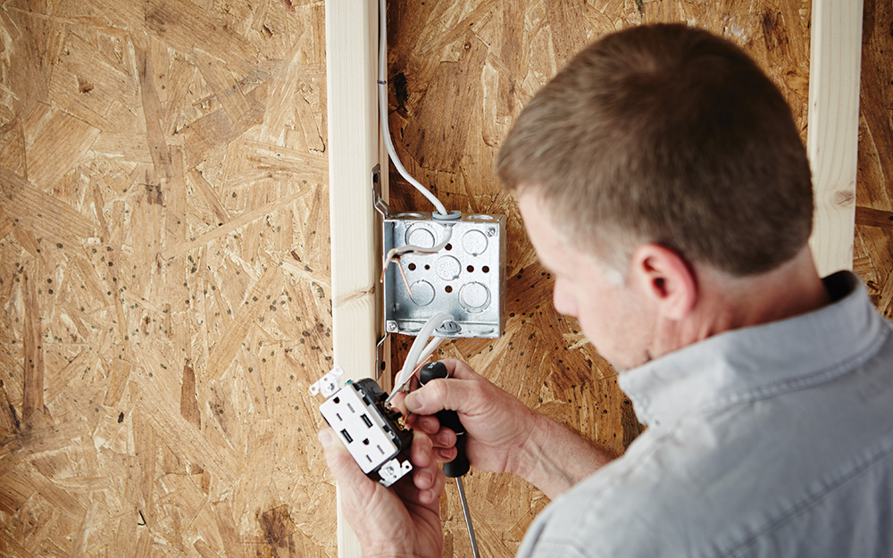 Man installing an electrical box.