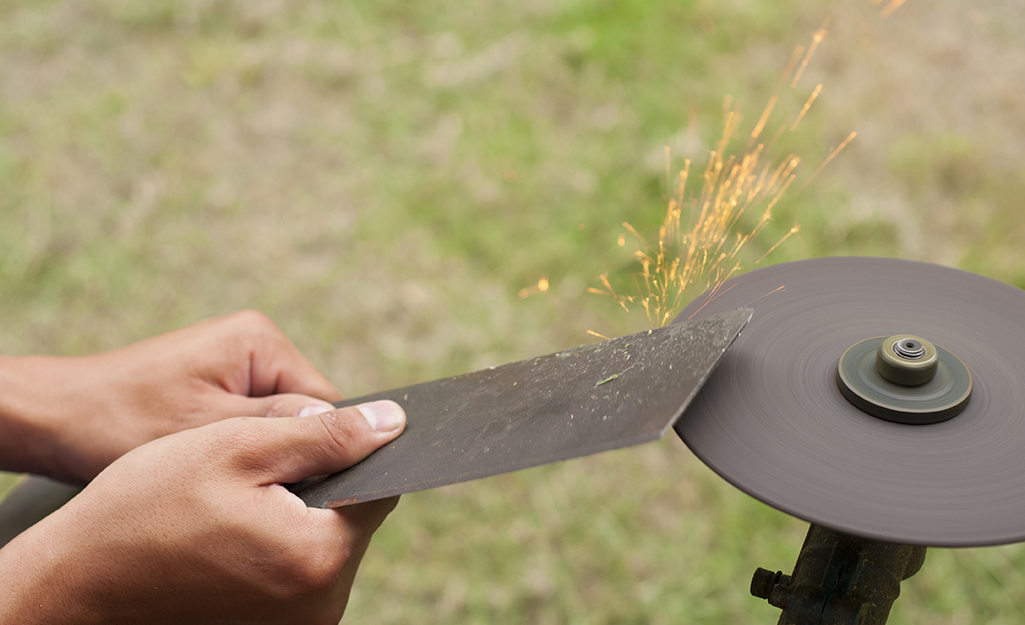 Someone sharpening mower blades. Someone sharpening mower blades.